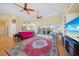 Open concept living room boasts wood floors, built-in shelving, and views of the pool at 16531 San Edmundo Rd, Punta Gorda, FL 33955