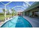 Inviting screened-in pool with spacious patio area and lush tropical landscaping offers ultimate relaxation at 16531 San Edmundo Rd, Punta Gorda, FL 33955