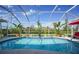 Sparkling pool with sunny skies shows a luxurious outdoor living space at 16531 San Edmundo Rd, Punta Gorda, FL 33955