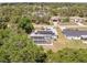 Charming home featuring a screened-in pool, solar panels and lush surrounding trees and landscaping at 1702 Rice Ter, North Port, FL 34286