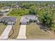 Close up aerial view of the home showing the front yard, driveway, and the exterior of the home at 1702 Rice Ter, North Port, FL 34286