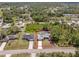 Bird's eye view of the property showing the home, driveway, and the trees behind it at 1702 Rice Ter, North Port, FL 34286