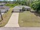 Aerial view of the home showing the manicured lawn, driveway, and the two car garage at 1702 Rice Ter, North Port, FL 34286