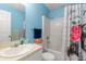 Bathroom featuring a single sink vanity, shower-tub combination, and stylish shower curtain at 1702 Rice Ter, North Port, FL 34286
