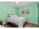 Bright bedroom with wood floors, ceiling fan, and window allowing natural light at 1702 Rice Ter, North Port, FL 34286