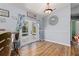 Bright dining area with wood floors, stylish light fixture and French doors leading to pool at 1702 Rice Ter, North Port, FL 34286