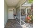 Charming front porch with decorative details and lush landscaping creating a welcoming entrance at 1702 Rice Ter, North Port, FL 34286
