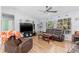 Cozy living room with wood floors, comfortable seating, and plenty of natural light at 1702 Rice Ter, North Port, FL 34286
