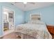 Spacious main bedroom featuring wood floors, ceiling fan, and an ensuite bathroom at 1702 Rice Ter, North Port, FL 34286