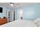 Spacious main bedroom featuring wood floors, ceiling fan, walk-in closet, and ensuite bathroom at 1702 Rice Ter, North Port, FL 34286