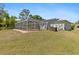 Exterior pool with a screened enclosure and view of the yard, perfect for summer fun at 1702 Rice Ter, North Port, FL 34286
