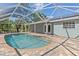 Inviting screened-in pool area with brick pavers, perfect for relaxation and outdoor enjoyment at 1702 Rice Ter, North Port, FL 34286