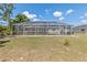 Well-maintained screened pool with outdoor area, ideal for leisure and entertainment at 1702 Rice Ter, North Port, FL 34286
