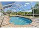 Inviting screened pool area with serene view, perfect for relaxation and recreation at 1702 Rice Ter, North Port, FL 34286