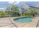 Relaxing screened pool with brick pavers and shaded by trees, perfect for outdoor enjoyment at 1702 Rice Ter, North Port, FL 34286