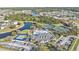 Stunning aerial view showcasing community amenities including pool, tennis and basketball courts, and a scenic lake at 1859 Scarlett Ave, North Port, FL 34289
