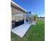 Backyard featuring a screened patio, lush green grass and a view of the pond at 1859 Scarlett Ave, North Port, FL 34289