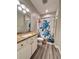 Bathroom featuring a granite vanity, white cabinets, and decorative shower curtain at 1859 Scarlett Ave, North Port, FL 34289