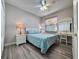 Bright bedroom offers ample natural light, complemented by wood-look floors and a charming vanity area at 1859 Scarlett Ave, North Port, FL 34289