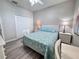 Comfortable bedroom includes generous closet space, complemented by wood-look flooring and soft, natural light at 1859 Scarlett Ave, North Port, FL 34289