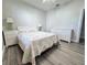 Comfortable bedroom includes ample space, complemented by wood-look flooring and soft, natural light at 1859 Scarlett Ave, North Port, FL 34289