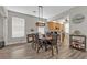 Open-concept dining room with hardwood floors, chandelier, and a view into the kitchen at 1859 Scarlett Ave, North Port, FL 34289