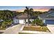 Charming single-story home with well-manicured landscaping, palm tree, and a two-car garage at 1859 Scarlett Ave, North Port, FL 34289