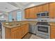 The kitchen features stainless steel appliances, granite countertops, wood-look floors, and a stainless steel sink at 1859 Scarlett Ave, North Port, FL 34289