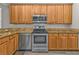Well-equipped kitchen showcasing stainless steel appliances, granite countertops, and light wood cabinetry at 1859 Scarlett Ave, North Port, FL 34289