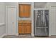 The kitchen features wood cabinets, stainless steel appliances, granite countertops, and wood-look floors at 1859 Scarlett Ave, North Port, FL 34289