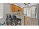 Cozy kitchen featuring granite countertops, wood cabinets and stainless steel microwave at 1859 Scarlett Ave, North Port, FL 34289