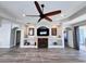 Spacious living room features fireplace, built-in shelving, ceiling fan and hardwood floors at 1859 Scarlett Ave, North Port, FL 34289
