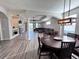 Open-concept living area with wood-look floors, dining area, and plenty of natural light at 1859 Scarlett Ave, North Port, FL 34289