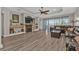 Comfortable living room featuring fireplace, luxury vinyl plank flooring, and cozy sectional couch at 1859 Scarlett Ave, North Port, FL 34289