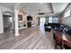 Open-concept living space with wood-look floors and cozy fireplace at 1859 Scarlett Ave, North Port, FL 34289