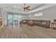Spacious living room with luxury vinyl plank flooring and large sliding glass doors to lanai at 1859 Scarlett Ave, North Port, FL 34289