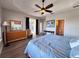 The main bedroom includes stylish ceiling fan, a view to the outdoor patio and a view of the ensuite bathroom at 1859 Scarlett Ave, North Port, FL 34289