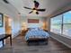 This main bedroom includes tray ceilings, sleek wood-look floors, and cozy window bench seating at 1859 Scarlett Ave, North Port, FL 34289