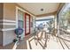 Cozy outdoor patio with grill, seating, and view of landscaped surroundings at 1859 Scarlett Ave, North Port, FL 34289