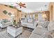 Spacious living room featuring modern decor, ceiling fan, wood floors, and dining area at 19171 Aviation Ct, Port Charlotte, FL 33948