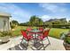 Private backyard oasis with lush landscaping, patio, and outdoor seating at 1944 Boddington Trl, Port Charlotte, FL 33980