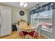 Cozy breakfast nook with round table, four chairs, and bright window with valance at 1944 Boddington Trl, Port Charlotte, FL 33980