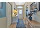 Bright entryway with a decorative rug, console table, and chandelier, leading into the home at 1944 Boddington Trl, Port Charlotte, FL 33980