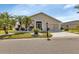 Charming single-story home featuring a well-manicured lawn with a bench and beautiful plants at 1944 Boddington Trl, Port Charlotte, FL 33980