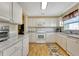 Bright kitchen features white cabinets, marble countertops, and stainless steel appliances at 1944 Boddington Trl, Port Charlotte, FL 33980