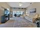 Spacious living room with plush seating, carpet flooring, and sliding glass doors to lanai at 1944 Boddington Trl, Port Charlotte, FL 33980