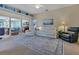 Bright living room featuring comfortable seating, stylish decor, and seamless access to the lanai at 1944 Boddington Trl, Port Charlotte, FL 33980