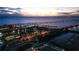 Aerial view of waterfront property at dusk, featuring illuminated buildings, bridges, and palm trees at 2002 Bal Harbor Blvd # 311, Punta Gorda, FL 33950
