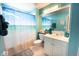 Bathroom with blue accents, complemented by a beach themed shower curtain at 2002 Bal Harbor Blvd # 311, Punta Gorda, FL 33950