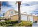 Charming two-story home exterior showcasing well-maintained landscaping, and a two-car garage for added convenience at 2002 Bal Harbor Blvd # 311, Punta Gorda, FL 33950